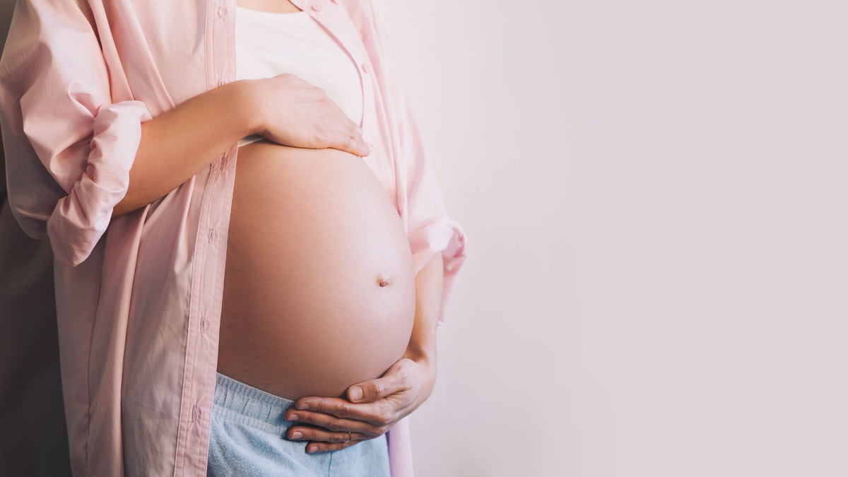 A pregnant woman holding her belly
